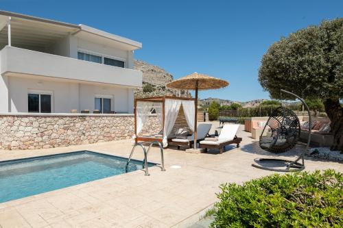 a villa with a swimming pool and a house at Villa Alia in Archangelos