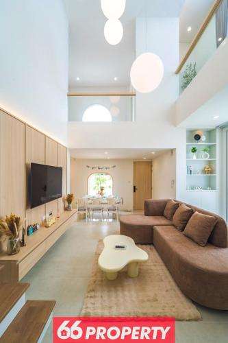 a living room with a couch and a table at Modern 4 BR Home - Walk to Shopping and Supermarket in Chiang Mai