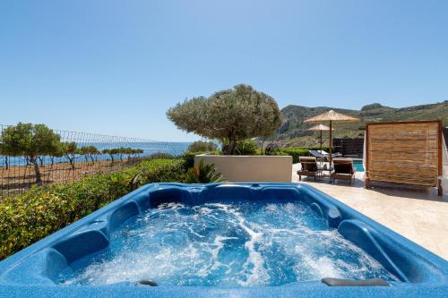 a blue hot tub sitting on top of a patio at Villa Alia in Archangelos