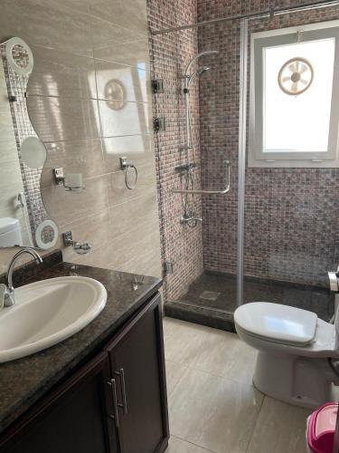 a bathroom with a sink and a shower and a toilet at Chalet at Mountain View Ras El Hekma in Ras Elhekma