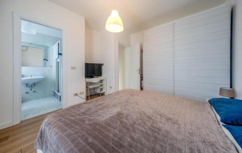 a bedroom with a bed and a bathroom with a sink at Il Bosco di Thiene in Thiene