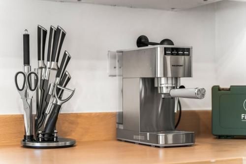 a coffee maker sitting on top of a counter at Spacious 3-Bed Home, Parking, Garden, Sleeps 7 in Brettell Lane