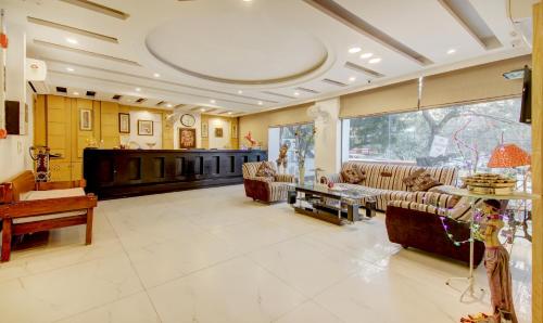 a large living room with couches and a table at Treebo The Kings Plaza in New Delhi