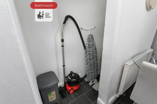 a bathroom with a mop and a vacuum in a corner at Two Bedroom House By Littlepiggyrentals Short Lets & Serviced Accommodation Chesterfield Central With Free Parking in Chesterfield