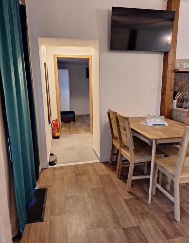 a kitchen and dining room with a table and chairs at APARTMÁNY Sninský dvor in Snina