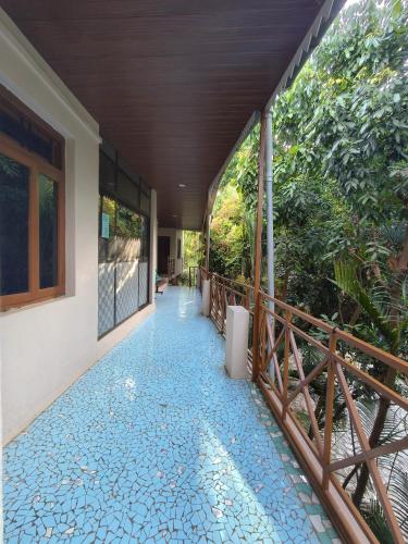 a hallway of a house with a wooden walkway at Anandi Villa Homestay in Adi