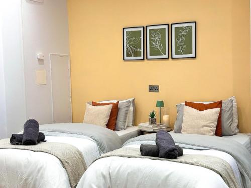 a room with three beds with towels on them at Colson - Best Find in Portsmouth, Sleeps 4, Centrally Located near City Centre, Gunwharf and University, Pool Table in Portsmouth