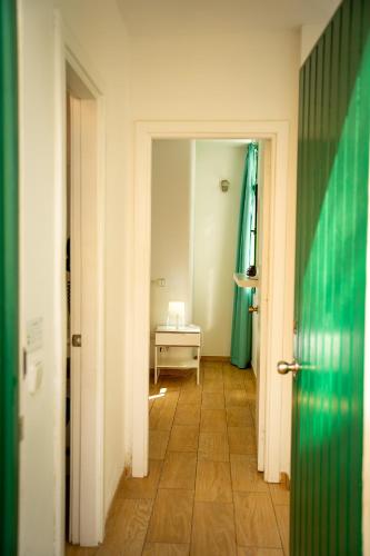 a hallway with a room with a table and a door at Apartamentos Halley in Puerto Rico de Gran Canaria