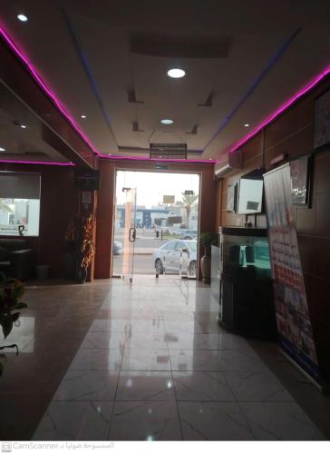 a restaurant entrance with a car parked in a parking lot at العييري للوحدات السكنيه المفروشة الاحساء 5 in Al Hofuf