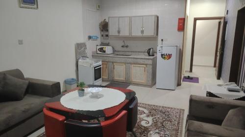 a kitchen with a couch and a table in a living room at العييري للوحدات السكنيه المفروشة الاحساء 5 in Al Hofuf