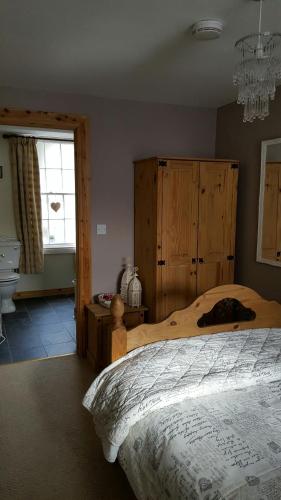 a bedroom with a bed and a chandelier at The Castle Apartment in Strangford