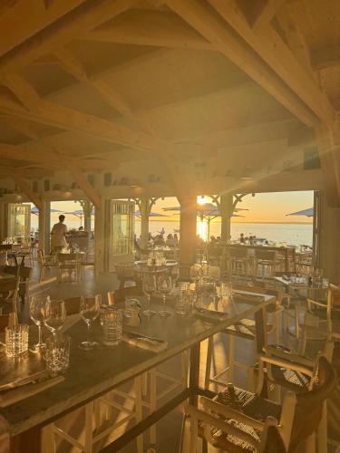 a restaurant with a view of the ocean at Hôtel de la Plage - Ronce-les-bains in Ronce-les-Bains