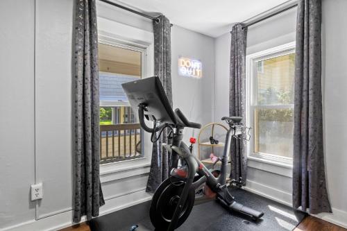 a room with a gym with a treadmill and a window at Walk to Ithaca Commons Bars Shops Trails and Close to Cornell in Ithaca