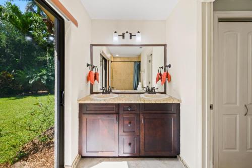 a bathroom with two sinks and a mirror at Private Entrance King Room and Private Bath UMiami in Miami