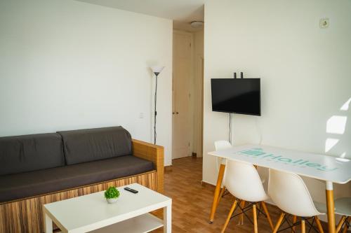 a living room with a couch and a table at Apartamentos Halley in Puerto Rico de Gran Canaria