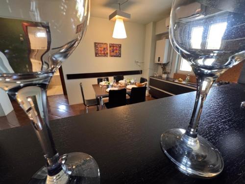 two wine glasses sitting on top of a table at Anna Apartment Timișoara in Timişoara
