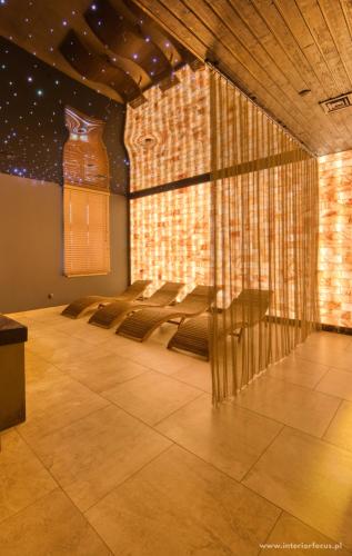 a room with a table and chairs in it at Golden Hotel & SPA in Inowrocław