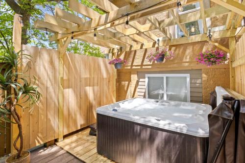 a hot tub in a backyard with a wooden fence at Walk to Ithaca Commons Bars Shops Trails and Close to Cornell in Ithaca