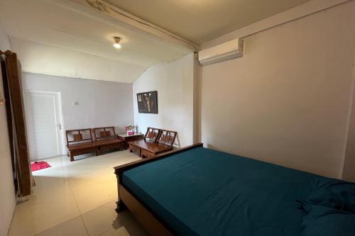 a bedroom with a bed and a table and chairs at Spot on Homestay Griya Sunarti in Yogyakarta