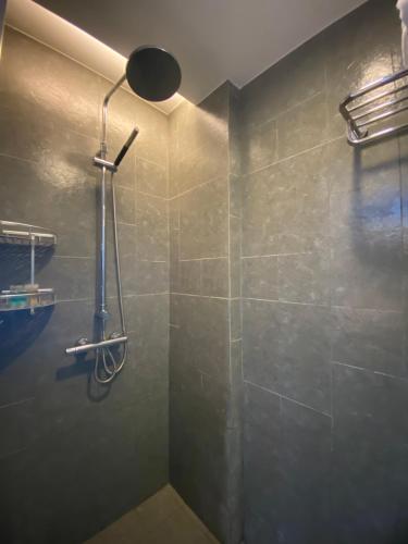 a bathroom with a shower with a shower head at Perfume Bay Tianhai Meiya B&B in Lingshui