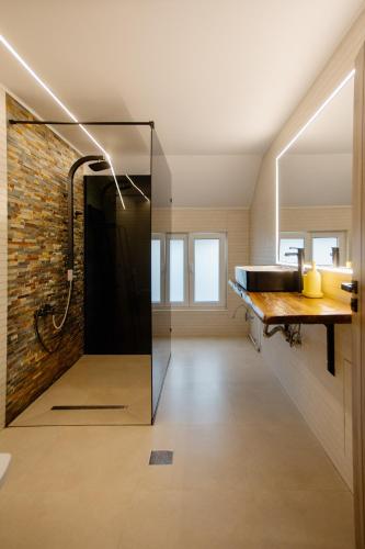 a bathroom with a shower and a brick wall at MOBstar in Alba Iulia