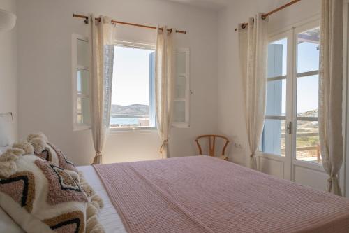 a bedroom with a bed with a view of the ocean at Cozy Sea View House in Agios Georgios