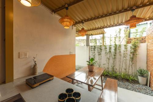 a living room with a table and chairs at Kim Quý Home in Phu Quoc