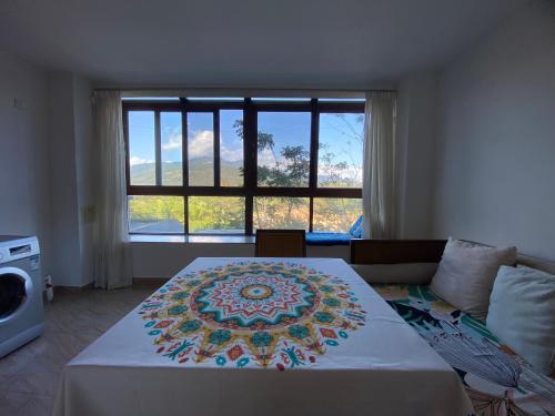 a bedroom with a bed with a large window at Perfume Bay Tianhai Meiya B&B in Lingshui