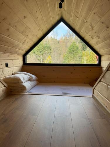 a room with a large window in a wooden house at Ostoja Zawoja in Zawoja
