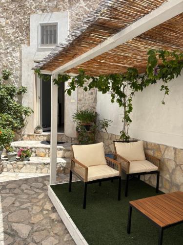 a patio with two chairs and a table at Il Giardino dei Limoni in Vieste