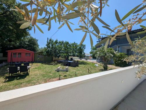 a view from the balcony of a house with a yard at Apolo Apartments in Pula