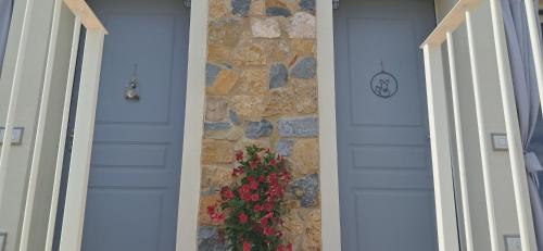 a door with a stone wall with a plant on it at Homeliday RELAX in Caldana