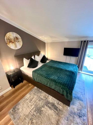 a bedroom with a large bed and a television at Hotel Garni BALTICpetite in Heringsdorf