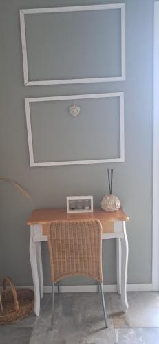 a table with a chair next to a white wall at Homeliday RELAX in Caldana