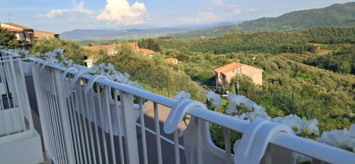 a white balcony with a view of a valley at Homeliday RELAX in Caldana