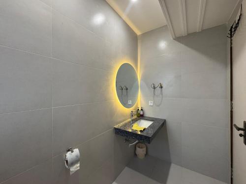 a bathroom with a sink and a mirror at Premium Pavilion in Islamabad