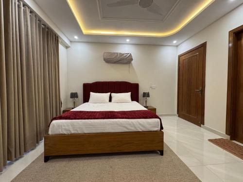 a bedroom with a large bed in a room at Premium Pavilion in Islamabad