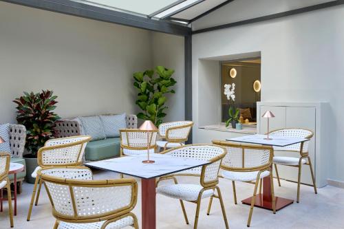 a restaurant with tables and chairs in a room at Wyndham Athens Residence in Athens