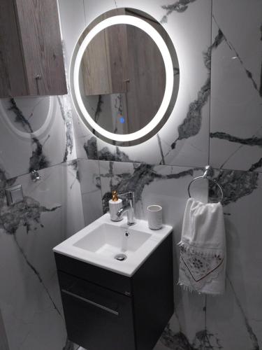 a bathroom with a sink and a mirror at Villa Atspas studios in Skala Marion