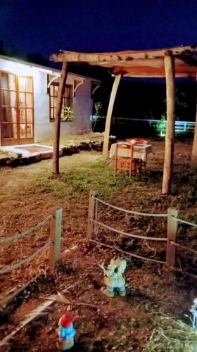 a yard with a fence and a table in front of a house at Παραδοσιακό σπιτι frozen in Elefterna