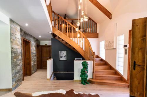 a staircase in a home with a stone wall at Villa - Détente & Jacuzzi aux portes de Gérardmer in Anould