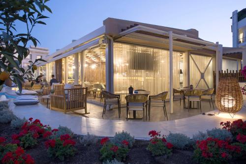 a patio with chairs and tables in a building at Wyndham Athens Residence in Athens