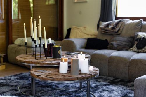 a living room with a table with candles on it at Villa - Détente & Jacuzzi aux portes de Gérardmer in Anould