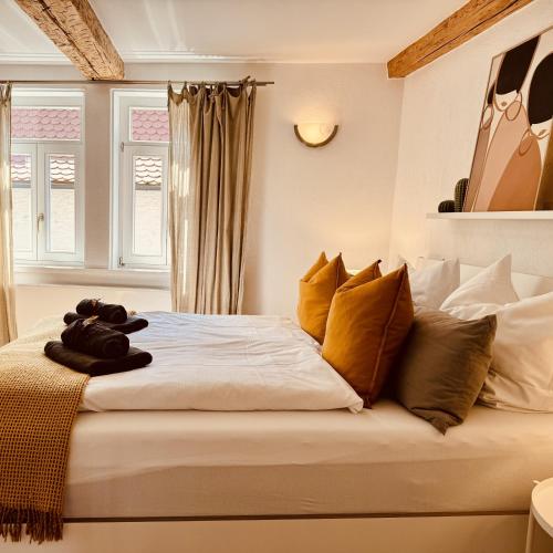 a bedroom with a large bed with yellow pillows at Altstadtglück Seligenstadt in Seligenstadt