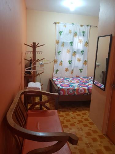 a small room with a bed and a window at Elsa's Place Tagaytay Transient House in Tagaytay