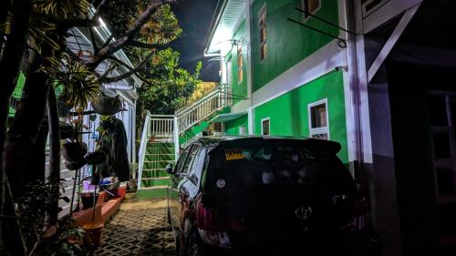 a car parked in front of a building at night at Elsa's Place Tagaytay Transient House in Tagaytay