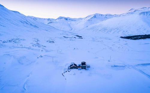 an aerial view of a snow covered mountain at Hóll Adventure House - Ævintýrahúsið Hóll á Siglufirði in Siglufjörður