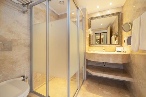 a bathroom with a shower and a toilet and a sink at Ali Bey Club & Park in Kizilagac