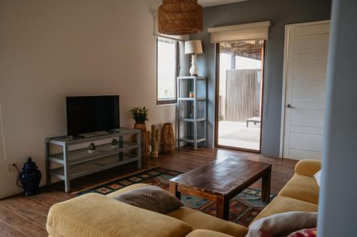 a living room with a couch and a television at El Sitio Penthouse in Playa Venao