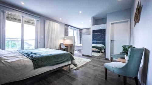 a bedroom with a bed and a chair and a desk at Vermont Hub for Offsites, Retreats & Individual Bookings in Alps in Leysin